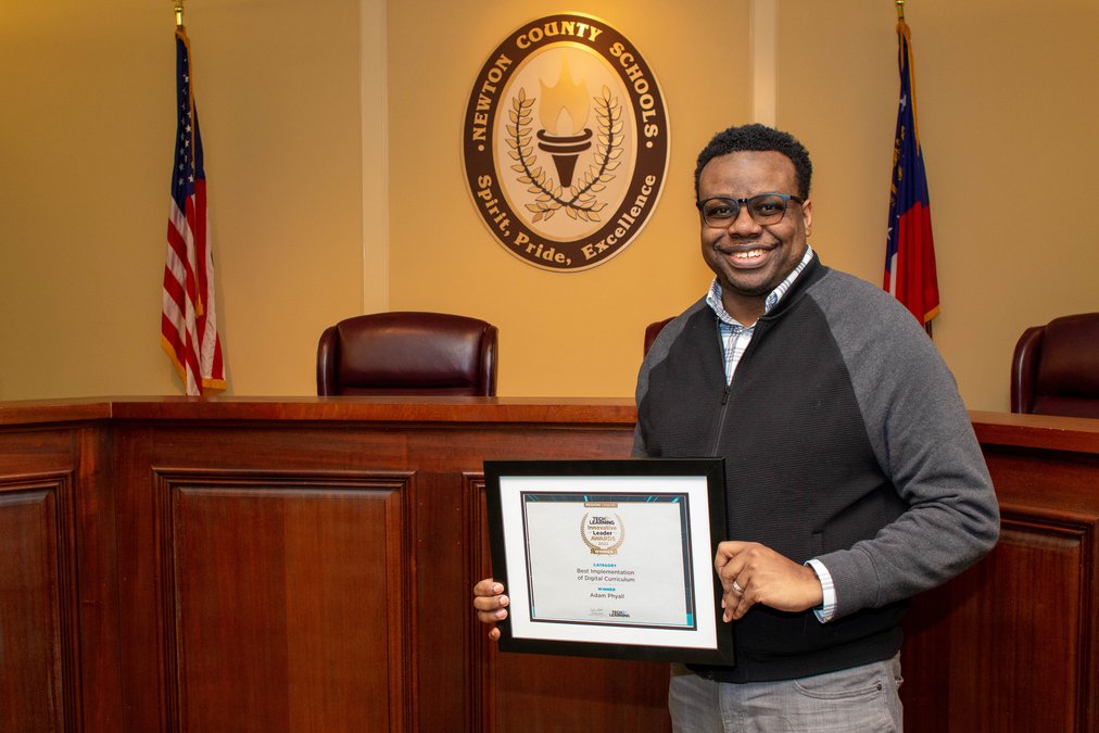 Dr. Adam Phyall receiving an award at Newton County Schools